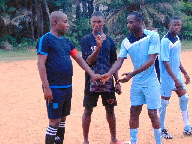 Principal Chea greets the captain of Greater Vision High School During a sport game